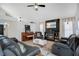 Cozy living room with a fireplace, plush seating, and a ceiling fan for added comfort at 1061 Providence Ln, Oviedo, FL 32765