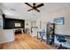Spacious living room with dark accent wall, sleek bamboo floors, modern furnishings, and an abundance of light at 1061 Providence Ln, Oviedo, FL 32765
