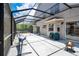 Large screened-in patio with a fire pit, lounge chairs, a hammock, and space for activities, perfect for relaxation at 1061 Providence Ln, Oviedo, FL 32765