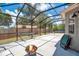 Screened patio with fire pit, hammock, lounging chairs, and space for games, perfect for relaxing and entertaining at 1061 Providence Ln, Oviedo, FL 32765
