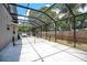 View of a screened-in patio with ample space for activities such as badminton in the backyard at 1061 Providence Ln, Oviedo, FL 32765
