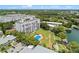 Aerial view of condo with manicured landscaping, pool, and access to the bay at 1100 S Orlando Ave # 206, Maitland, FL 32751