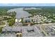 Community buildings and road nestled among mature trees, condos with lake views at 1100 S Orlando Ave # 206, Maitland, FL 32751