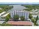 An aerial view of a condo building close to the lake surrounded by trees at 1100 S Orlando Ave # 206, Maitland, FL 32751