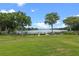 Manicured lawn leading to lakefront docks with boats, enhancing the property's appeal at 1100 S Orlando Ave # 206, Maitland, FL 32751