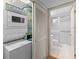 Small bathroom adjacent to the laundry unit has a shower and toilet at 1100 S Orlando Ave # 206, Maitland, FL 32751