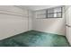 Bedroom with a window letting in light and having green carpet at 1100 S Orlando Ave # 206, Maitland, FL 32751