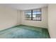 Bedroom featuring green carpet flooring and a large window with a lake view at 1100 S Orlando Ave # 206, Maitland, FL 32751