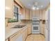 Traditional kitchen with white appliances, tile floors, laminate countertops, and a ceiling fan at 1100 S Orlando Ave # 206, Maitland, FL 32751