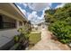 Lush backyard landscaping with a small shed and concrete walkway at 1105 Arrowsmith Ave, Orlando, FL 32809
