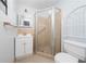 Neat bathroom with a tiled shower, single sink vanity and modern toilet at 1105 Arrowsmith Ave, Orlando, FL 32809