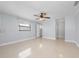 Light-filled bedroom with tile floors, ceiling fan, and access to a walk-in closet at 1105 Arrowsmith Ave, Orlando, FL 32809