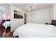 Bright bedroom with a bed, ceiling fan, mirrored closet doors, and a colorful painting at 1105 Arrowsmith Ave, Orlando, FL 32809