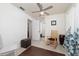 Inviting bedroom with ceiling fan, rocking chair and doorway to another room at 1105 Arrowsmith Ave, Orlando, FL 32809