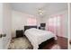 Bedroom features wood floors, a bed, nightstands, a ceiling fan, and sheer curtains at 1105 Arrowsmith Ave, Orlando, FL 32809