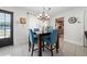 Stylish dining area with a modern table set, chandelier, and great natural light from the window at 1105 Arrowsmith Ave, Orlando, FL 32809