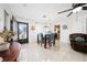 Bright dining room with stylish table set, chandelier, and a view of the adjacent living area at 1105 Arrowsmith Ave, Orlando, FL 32809