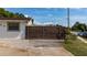 Ornate metal security gate enhancing the curb appeal and security of this single-story home at 1105 Arrowsmith Ave, Orlando, FL 32809