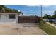 Exterior shot of home featuring large decorative gate and driveway at 1105 Arrowsmith Ave, Orlando, FL 32809