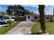 Charming home with a well-manicured lawn, mature trees, and a private driveway at 1105 Arrowsmith Ave, Orlando, FL 32809
