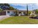Charming single-story home featuring a well-manicured front yard with mature trees and beautiful landscaping at 1105 Arrowsmith Ave, Orlando, FL 32809