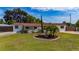 Single-story home showcasing a lush front lawn, mature trees, and decorative fountain feature at 1105 Arrowsmith Ave, Orlando, FL 32809