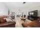 Spacious living room with comfortable leather seating, a dining area, and great natural lighting at 1105 Arrowsmith Ave, Orlando, FL 32809