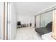 The room features white tile floor, massage table, office furniture and a sliding glass door at 1105 Arrowsmith Ave, Orlando, FL 32809