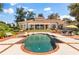 Expansive backyard showcasing a sparkling pool, meticulously landscaped grounds, and a charming patio area at 1351 N Classic Ct, Longwood, FL 32779