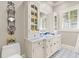 Bright bathroom with custom blue tile accents, storage cabinet and decorative wall art at 1351 N Classic Ct, Longwood, FL 32779