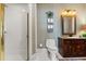 Cozy bathroom with walk-in shower, vanity, and patterned wallpaper at 1351 N Classic Ct, Longwood, FL 32779