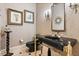 Elegant powder room featuring a black marble vanity, ornate mirror, and stylish accents at 1351 N Classic Ct, Longwood, FL 32779