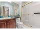 Traditional bathroom with a wooden vanity, framed mirror, and enclosed shower at 1351 N Classic Ct, Longwood, FL 32779