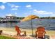 Beach area with chairs and umbrella, offering a relaxing waterfront experience at 1351 N Classic Ct, Longwood, FL 32779