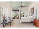 Spacious bedroom with a four-poster bed, sitting area, large windows, and tasteful decor at 1351 N Classic Ct, Longwood, FL 32779