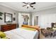 Grey bedroom features a wicker chair, ensuite bathroom, and views into the living space at 1351 N Classic Ct, Longwood, FL 32779