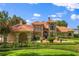 Stately home with a red tile roof, lush landscaping, and a beautiful entry way at 1351 N Classic Ct, Longwood, FL 32779