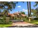 Beautiful waterfront home with a red tile roof and manicured landscaping at 1351 N Classic Ct, Longwood, FL 32779