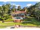 Expansive backyard featuring a luxurious pool, patio area, beautifully manicured landscaping and a sandy beach at 1351 N Classic Ct, Longwood, FL 32779