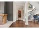 Grand foyer with curved staircase, hardwood floors, fireplace and adjacent library at 1351 N Classic Ct, Longwood, FL 32779