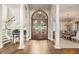 Grand foyer with a curved staircase, hardwood floors, and a decorative chandelier at 1351 N Classic Ct, Longwood, FL 32779