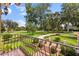 View of manicured front lawn from balcony with decorative wrought iron railing and elegant brick-paved entry at 1351 N Classic Ct, Longwood, FL 32779