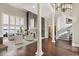 Open great room featuring high ceilings, columns, and views of the lake and staircase at 1351 N Classic Ct, Longwood, FL 32779