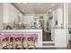 Bright kitchen featuring white cabinetry, marble countertops, a breakfast bar, and modern stainless steel appliances at 1351 N Classic Ct, Longwood, FL 32779