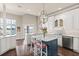 Bright kitchen features hardwood floors, marble counters, a center island and scenic lake view at 1351 N Classic Ct, Longwood, FL 32779