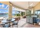 Spacious covered patio with an outdoor dining area, overlooking the pool and lake views at 1351 N Classic Ct, Longwood, FL 32779