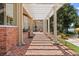 Covered brick patio with shade and manicured landscaping, perfect for outdoor entertaining by the pool at 1351 N Classic Ct, Longwood, FL 32779