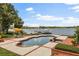 Beautiful pool overlooking the lake with a dock and sitting area, perfect for relaxing and entertaining guests at 1351 N Classic Ct, Longwood, FL 32779