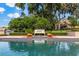 Relaxing lakeside pool with a bench, plants, and a picturesque view of the water at 1351 N Classic Ct, Longwood, FL 32779