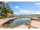Waterfront home with a pool and a patio area that offers scenic views of the lake and surrounding landscape at 1351 N Classic Ct, Longwood, FL 32779